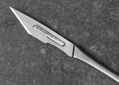 A photograph of a scalpel to illustrate the poem “Op Techs” by Lida Broadhurst, published in issue 18 of Neon