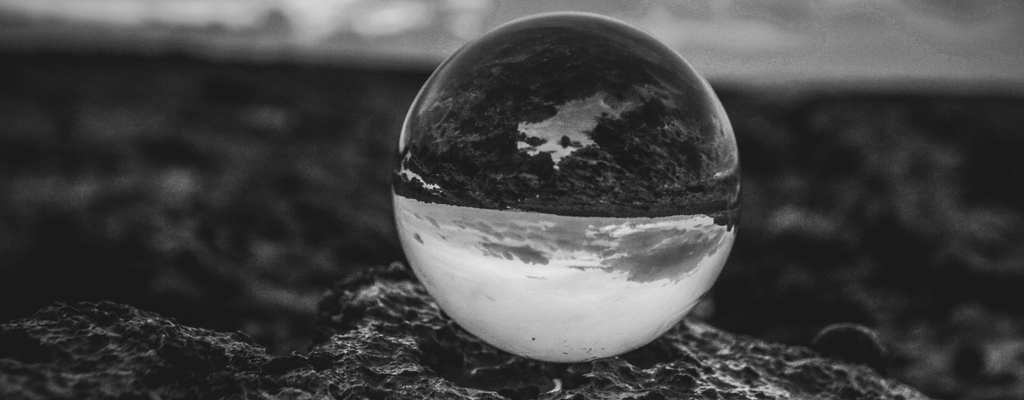 A photograph of a glass sphere to illustrate the poem "Endless Dream" by Mack W Mani, published in issue 50 of Neon